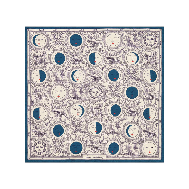 The Tiny Finch square silk scarf featuring a blue and white celestial moon phase print with anthropomorphic faces.