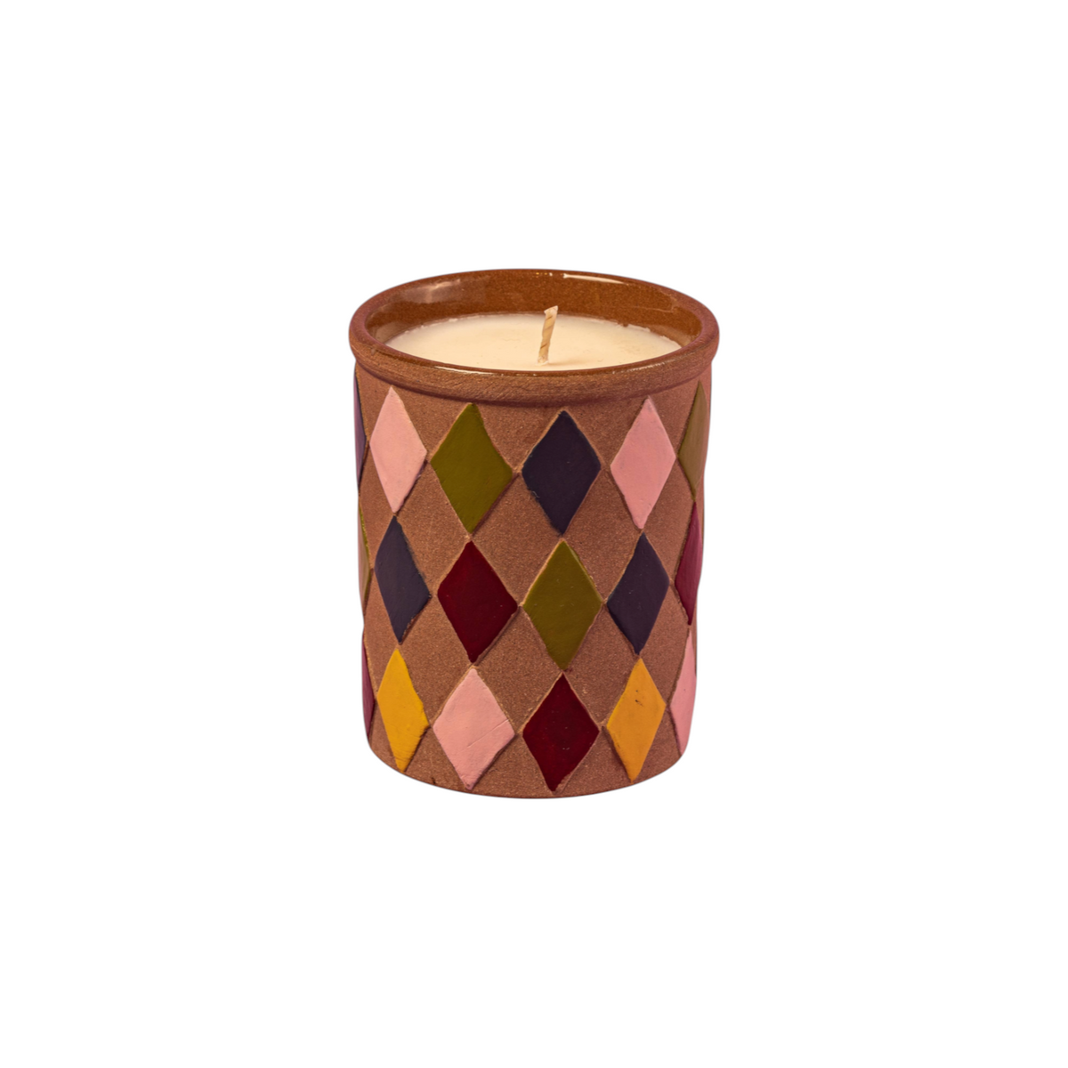 The Tiny Finch Maegen candle in a sand-textured ceramic pot with a colorful diamond harlequin pattern.