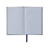 The Tiny Finch navy Panama pocket notebook open to show lined pale blue Featherweight paper and a ribbon bookmark.
