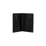 The Tiny Finch blue crossgrain leather passport cover open with gold-stamped boarding pass and passport pockets.