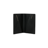 The Tiny Finch black crossgrain leather passport cover open with gold-stamped pockets for passport and boarding pass
