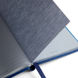 The Tiny Finch Panama pocket notebook in cerulean crossgrain leather with gilt-edged pale blue lined paper
