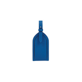 The Tiny Finch cerulean blue crossgrain leather luggage tag with an adjustable strap and tonal topstitching.