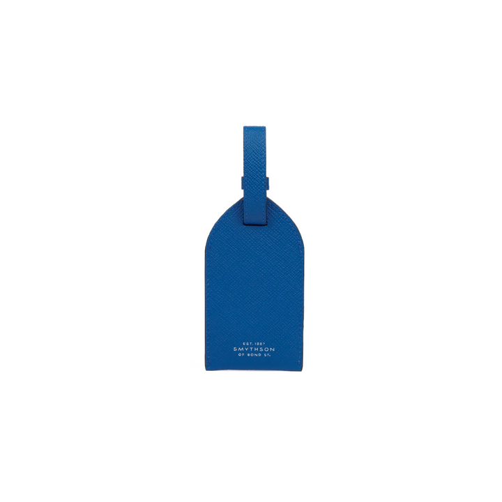 The Tiny Finch Smythson cerulean blue crossgrain calf leather luggage tag with adjustable strap and tonal stitching.