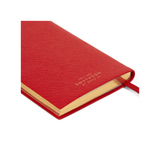 The Tiny Finch red crossgrain leather Panama pocket notebook with gilt-edged pages and a ribbon marker.