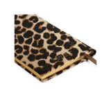 The Tiny Finch Panama pocket notebook in leopard print crossgrain leather with gilt-edged pages and ribbon marker.