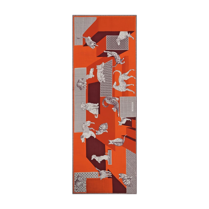 The Tiny Finch Les Cheris red wool scarf featuring a geometric pattern with illustrated cats and dogs.