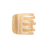 The Tiny Finch mini hair claw clip in a translucent chamois beige Italian bio-acetate finish.
