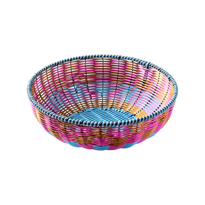 The Tiny Finch Maegen hand-woven bowl in hot pink, blue, and gold polypropylene in a textured faux rattan style.