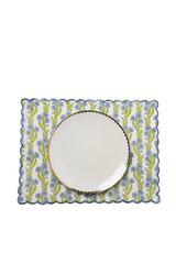 The Tiny Finch cotton placemat with blue floral blockprint, scalloped embroidered edges, and a white dinner plate.