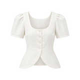 The Tiny Finch Audrey white linen vest with scoop neckline, button front, and gathered cap sleeves.