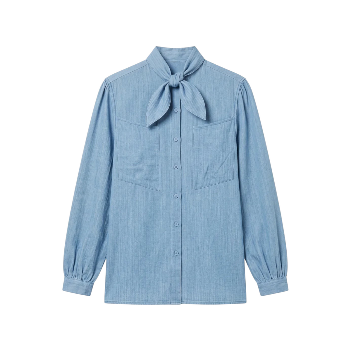 The Tiny Finch Charlie blouse in light blue cotton denim featuring a neck tie, patch pockets, and gathered cuffs.