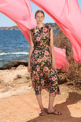 The Tiny Finch Margaret midi skirt in a floral print tencel and cotton blend, worn by a model at the beach.