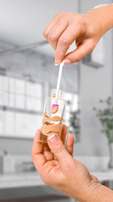 The Tiny Finch Beauty Spatty tool removing foundation from a glass bottle to minimize product waste.