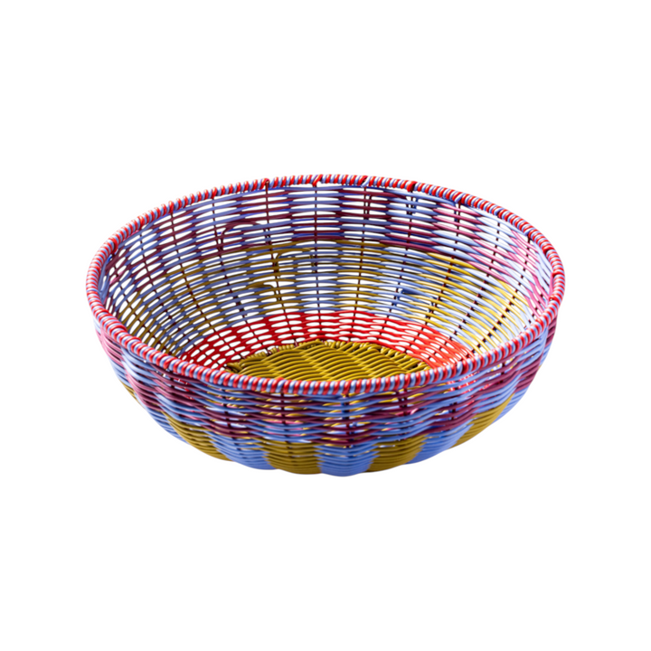 The Tiny Finch Maegen hand-woven polypropylene bowl in cornflower blue, red, and yellow with a textured rattan style.