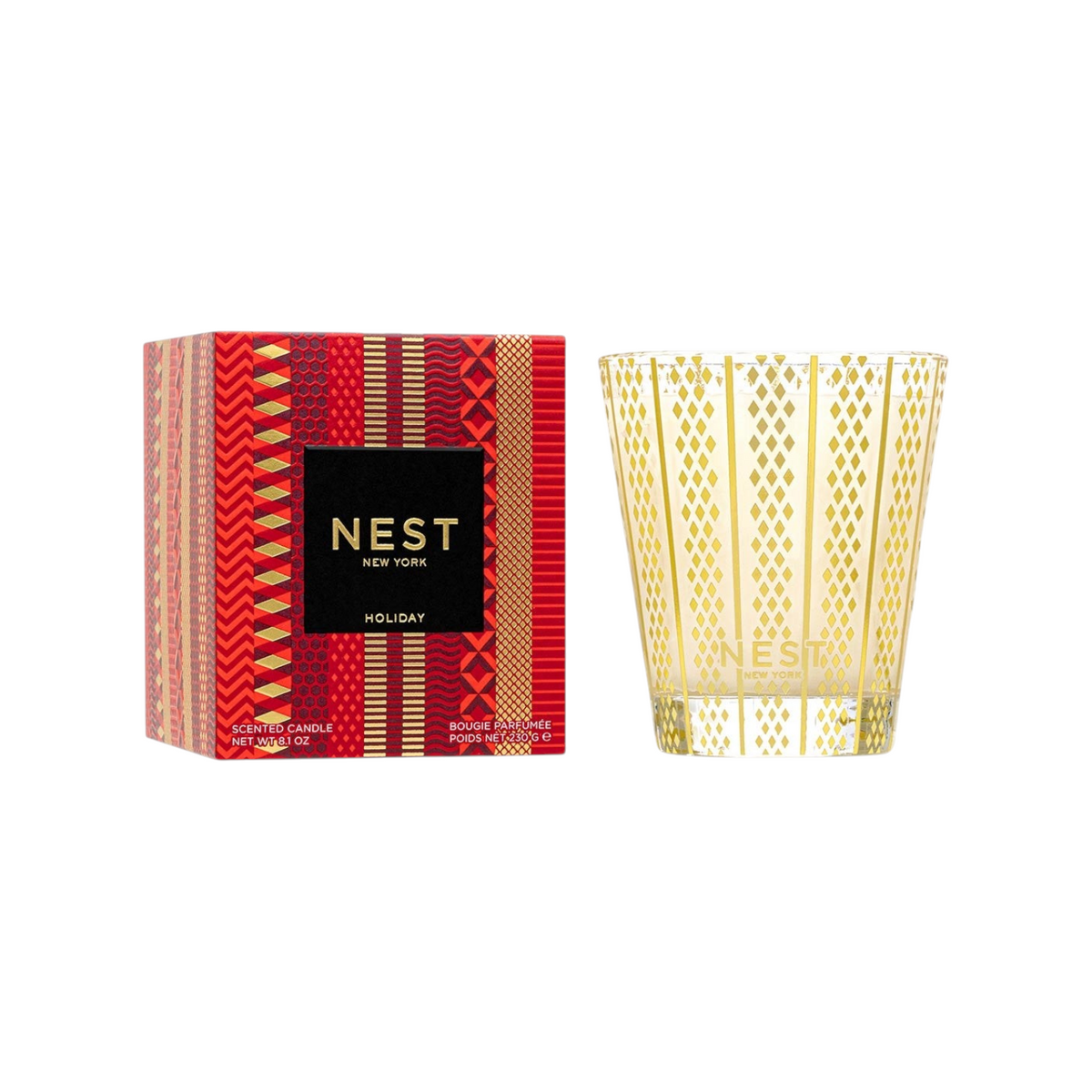 The Tiny Finch Nest Holiday Classic candle in a gold patterned glass jar next to its red and gold decorative box.
