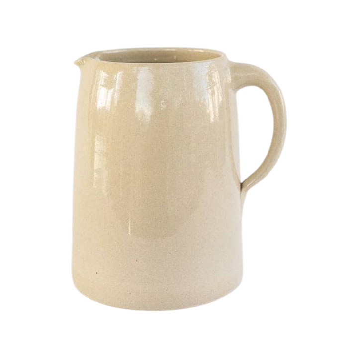 The Tiny Finch handmade stoneware pitcher in a neutral beige glaze, featuring a classic farmhouse design.
