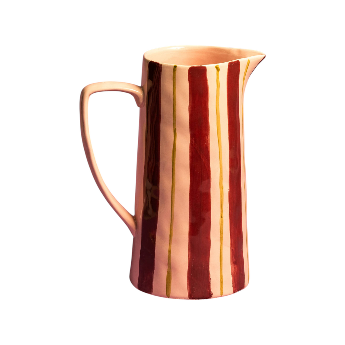 The Tiny Finch Maegen ceramic jug with a light pink base, burgundy stripes, and hand-painted ochre accents.