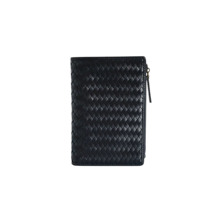 The Tiny Finch Elio navy blue handwoven leather travel organizer with multiple interior pockets and a side zipper.
