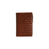 The Tiny Finch Elio travel organizer in sienna brown handwoven leather with multiple internal pockets and zipper.