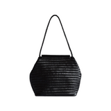 The Tiny Finch Vera black handwoven leather shoulder bag with a braided strap and structured bar-top opening.