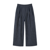 The Tiny Finch Kenny high-rise wide-leg linen pants in navy with white pinstripe detailing.