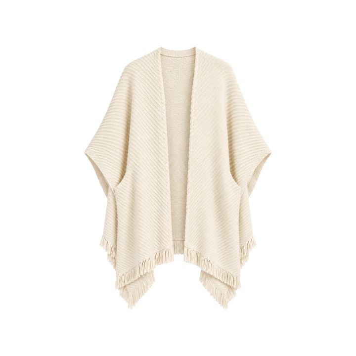 The Tiny Finch Ava cape in beige, handwoven from baby alpaca and organic pima cotton with delicate fringe detailing.
