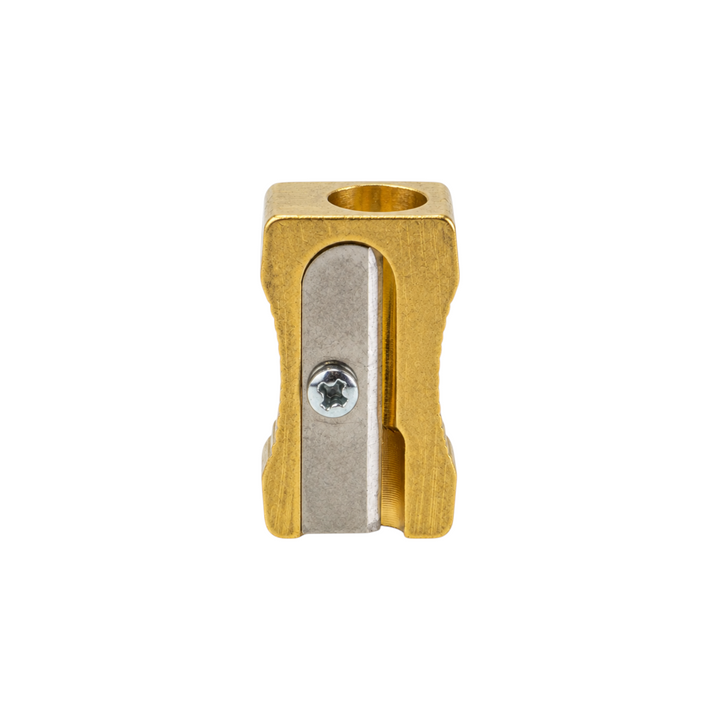 The Tiny Finch brass wedge pencil sharpener for standard pencils, featuring a durable metal design made in Germany.