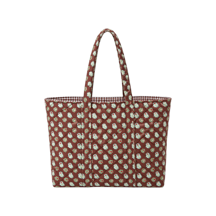 The Tiny Finch Georgia quilted tote bag in brown floral fabric with a gingham lining and comfortable shoulder straps.
