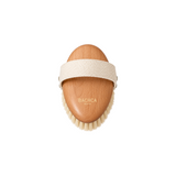 The Tiny Finch dry body brush with a wooden handle, cloth strap, and boar bristles for skin exfoliation.