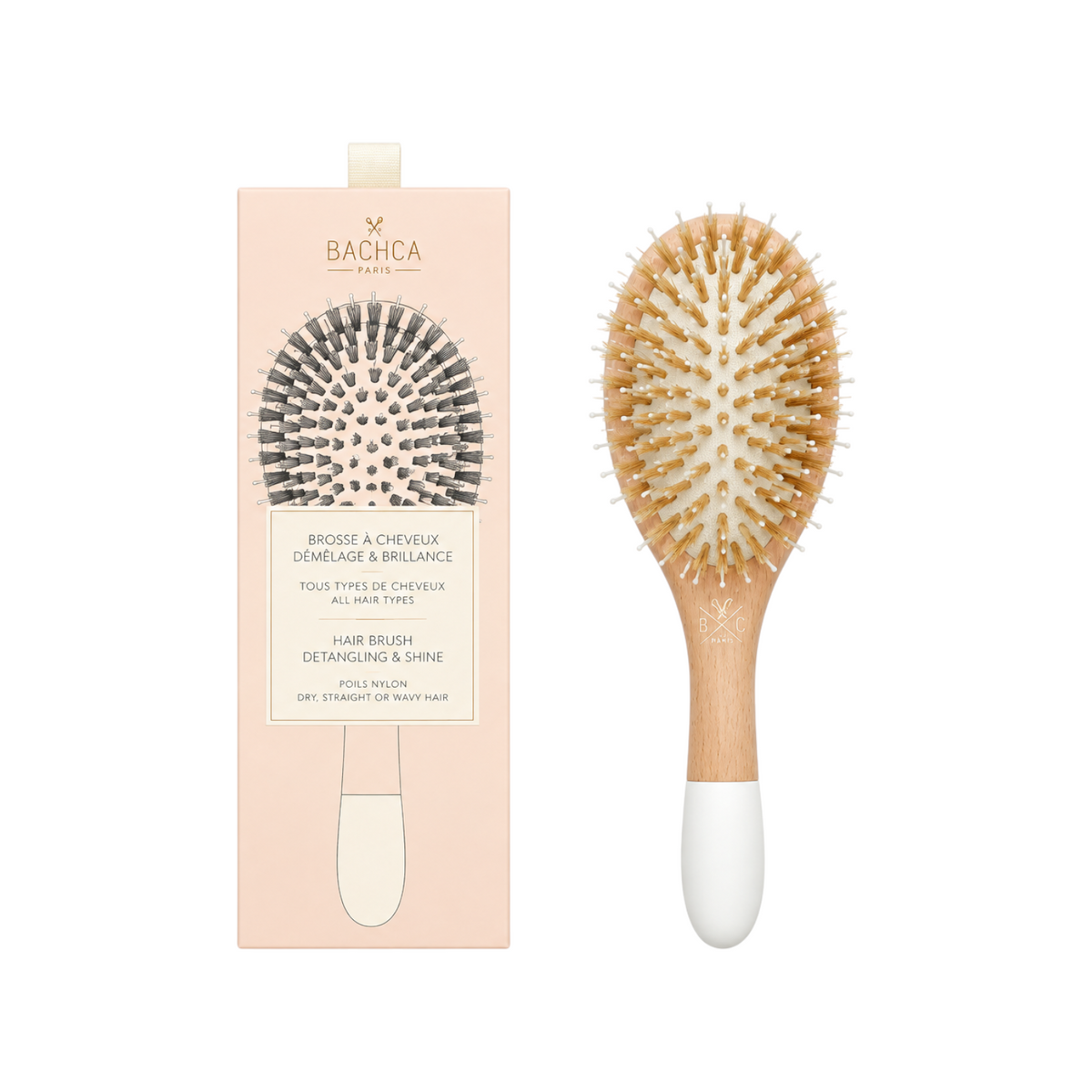 The Tiny Finch large wooden detangling hairbrush with boar bristles and nylon pins beside its blush pink packaging.