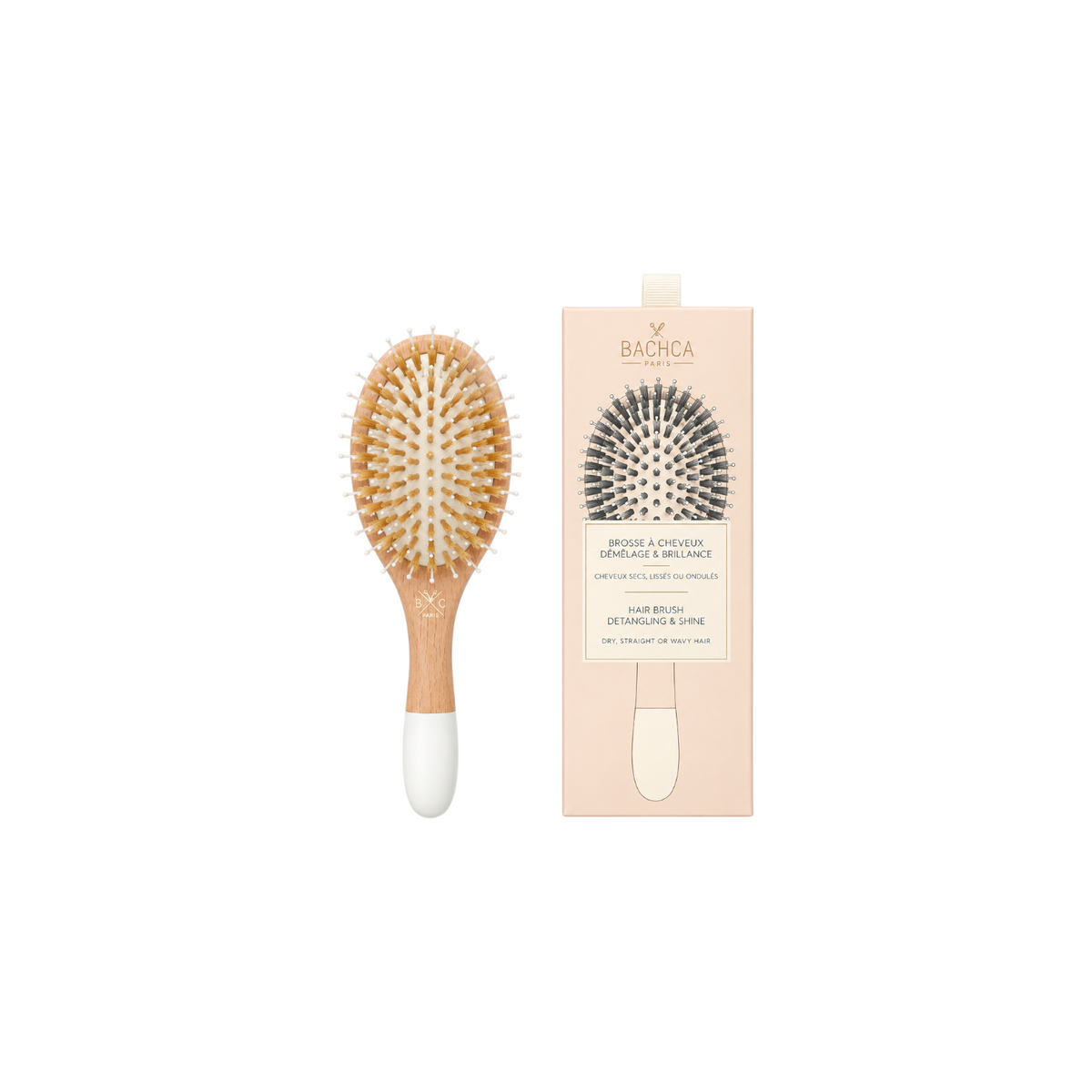 The Tiny Finch small wooden hairbrush with boar bristles and nylon pins beside its beige product packaging box.