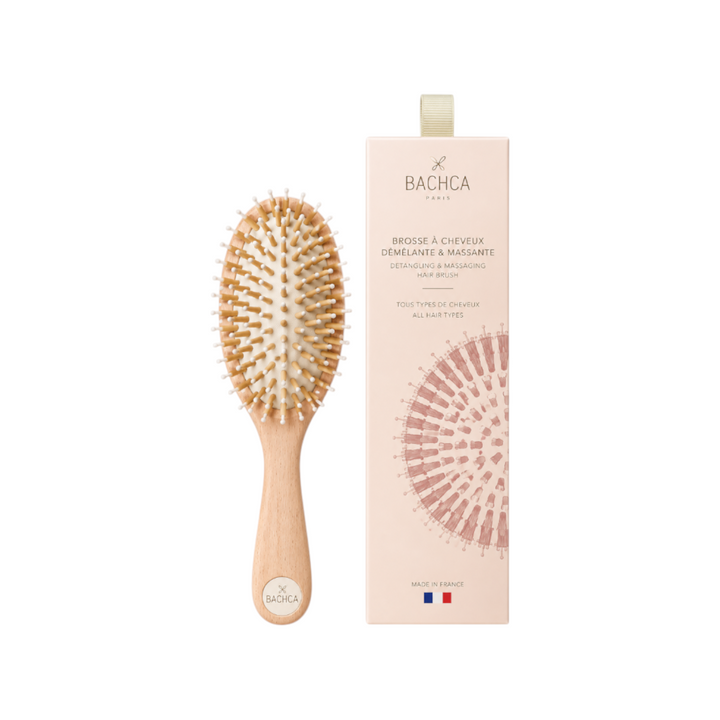 The Tiny Finch Care & Shine large hair brush with beechwood handle, boar bristles, and nylon pins next to its box.