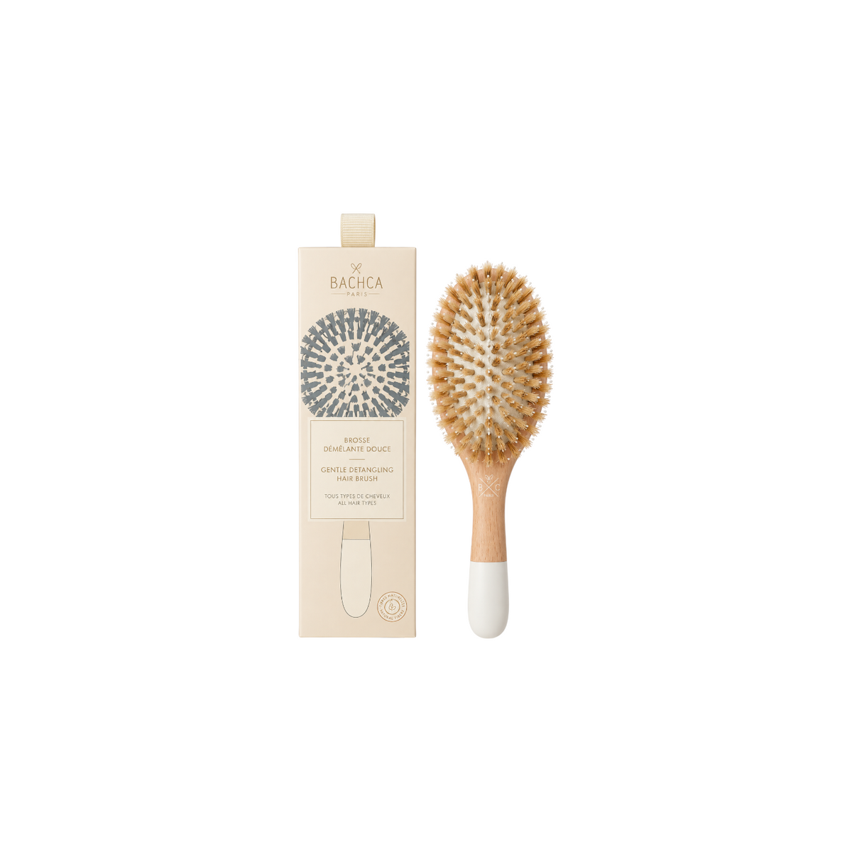 The Tiny Finch gentle hair brush with natural boar bristles and a light wood handle, shown with its product box.