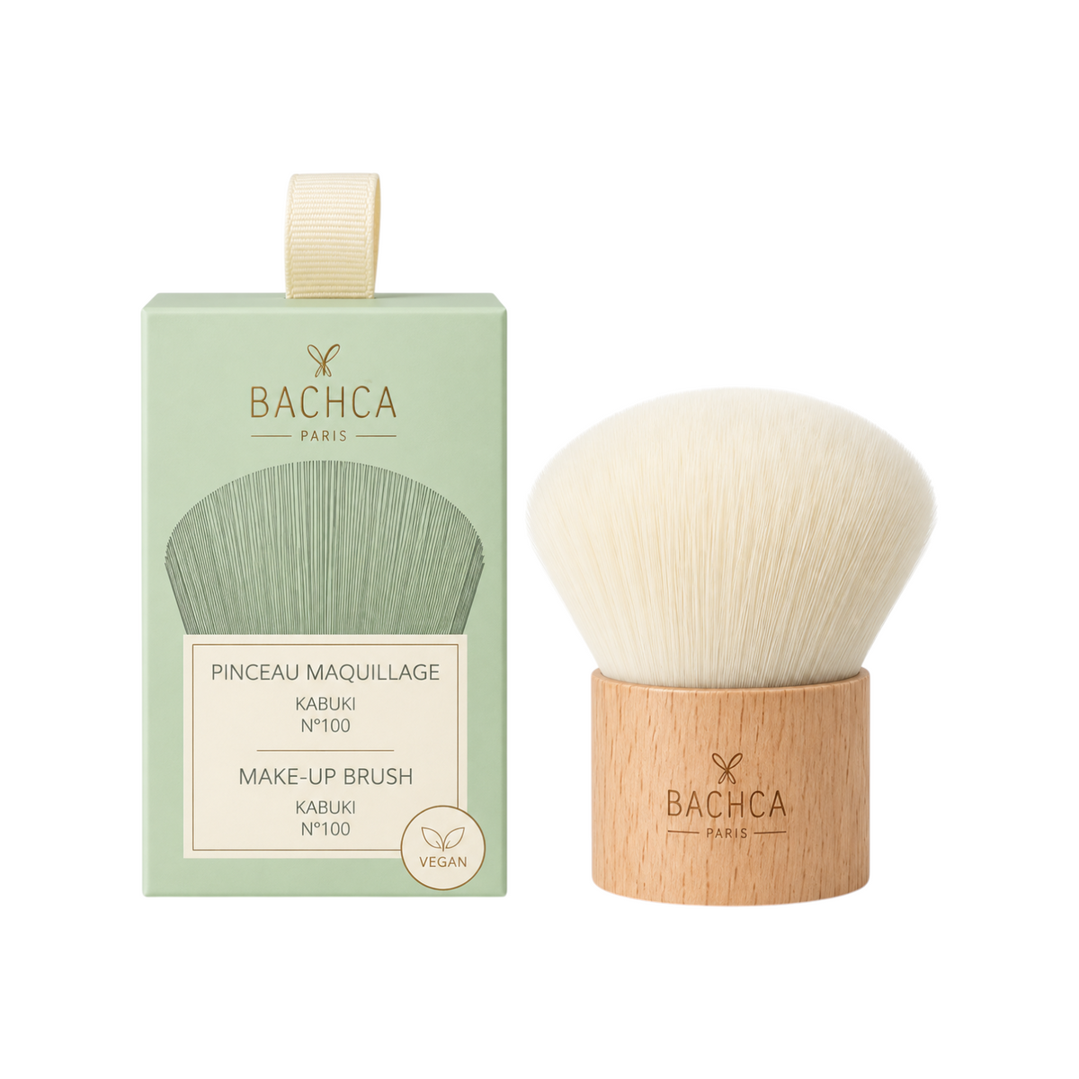 The Tiny Finch Kabuki makeup brush with soft synthetic bristles and a natural beechwood handle next to its box.