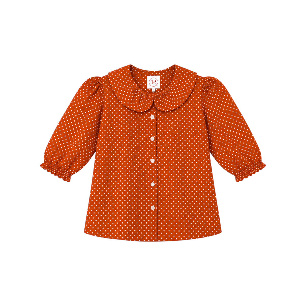The Tiny Finch Charlie Carrot Dot Top in orange cotton with white polka dots, Peter Pan collar, and puff sleeves.