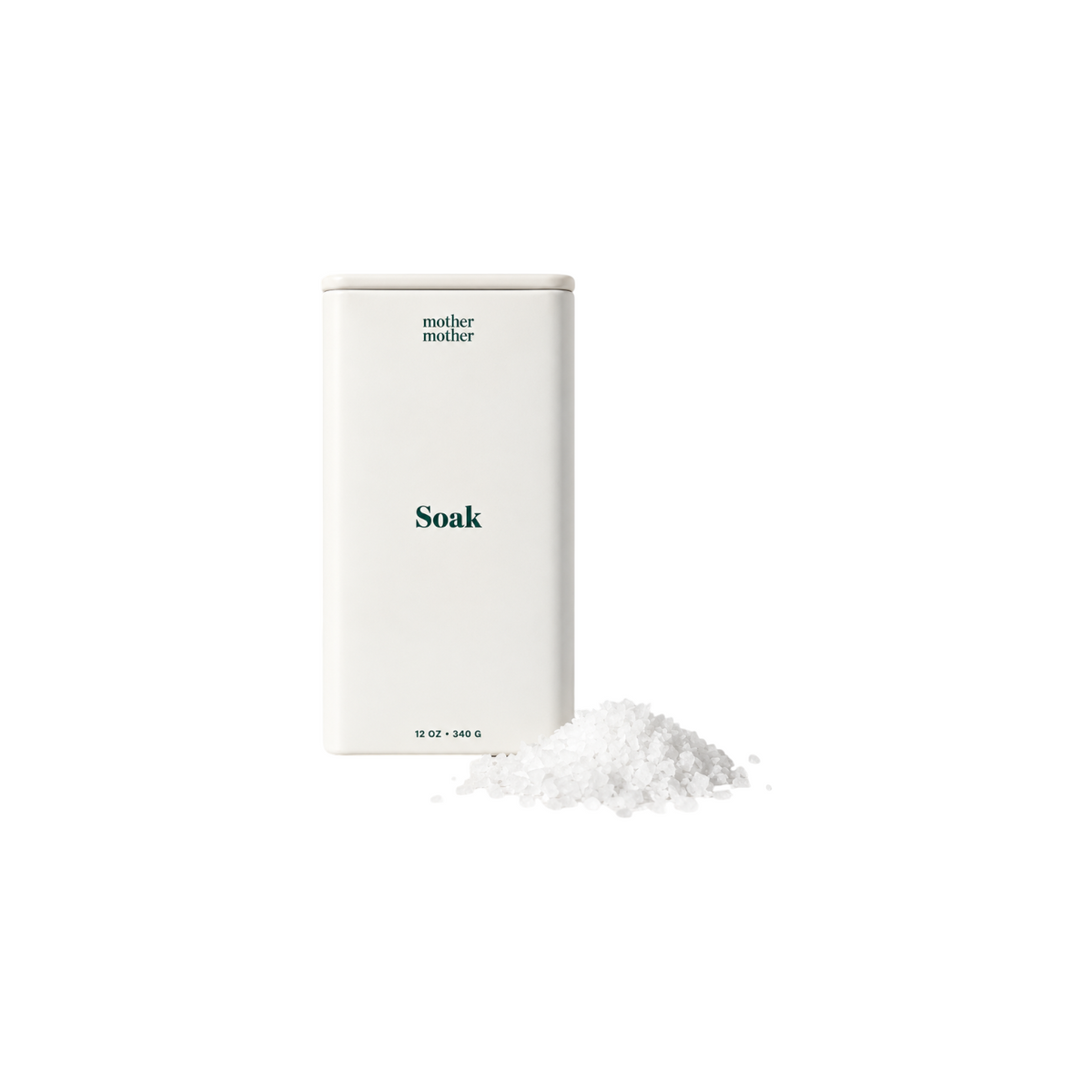The Tiny Finch magnesium bath soak in a white reusable tin with lavender and ylang ylang scented flakes on a surface.