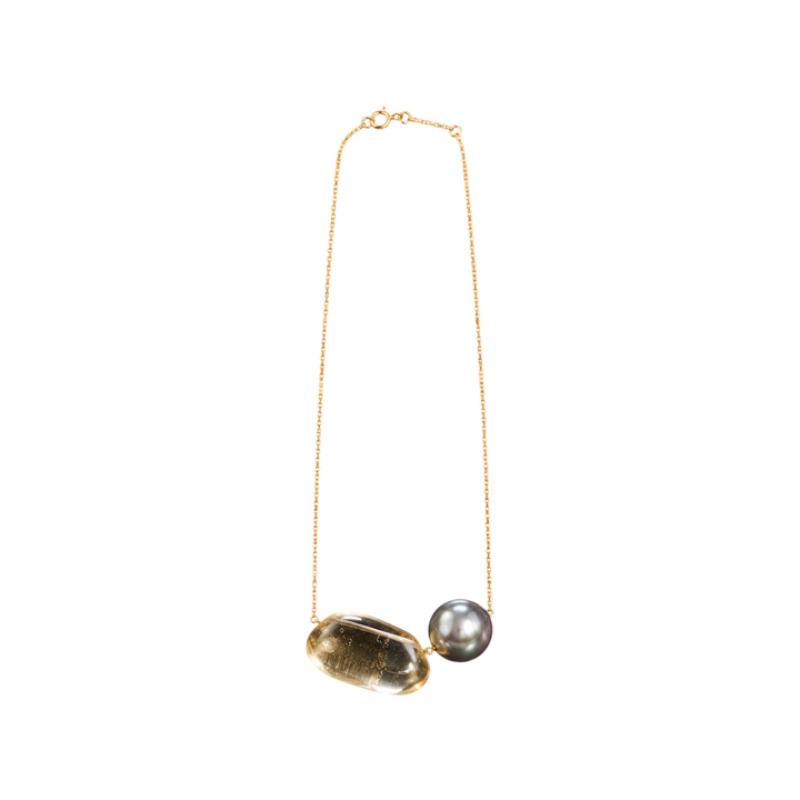 The Tiny Finch 18k gold necklace featuring a hand-cut lemon quartz tapiz bead and a grey Tahitian pearl.
