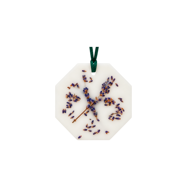 The Tiny Finch scented botanical palet featuring dried lavender flowers embedded in white vegetable wax with green ribbon