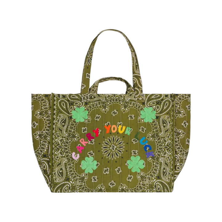 The Tiny Finch Maxi Cabas quilted bronze tote bag with green paisley print, embroidered clover, and colorful text.