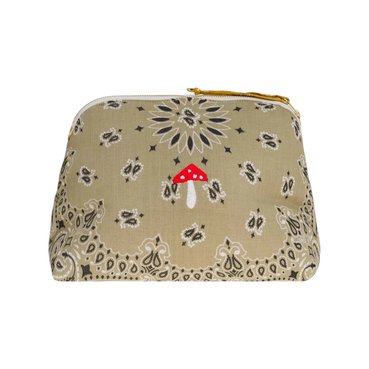 The Tiny Finch beige two-tone toiletry bag with a red mushroom embroidery and gold zipper closure.