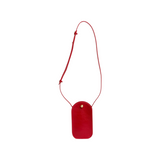 The Tiny Finch Segui Carmine red leather crossbody bag with an adjustable strap and gold stud closure.