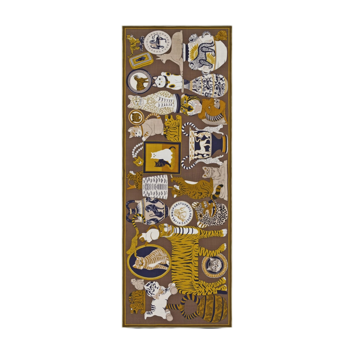 The Tiny Finch Inoui Editions Collectionneur khaki wool scarf featuring eclectic animal and ceramic motifs.