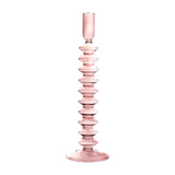 The Tiny Finch Maegen rose quartz pink glass taper candle holder with a decorative ribbed stem design.