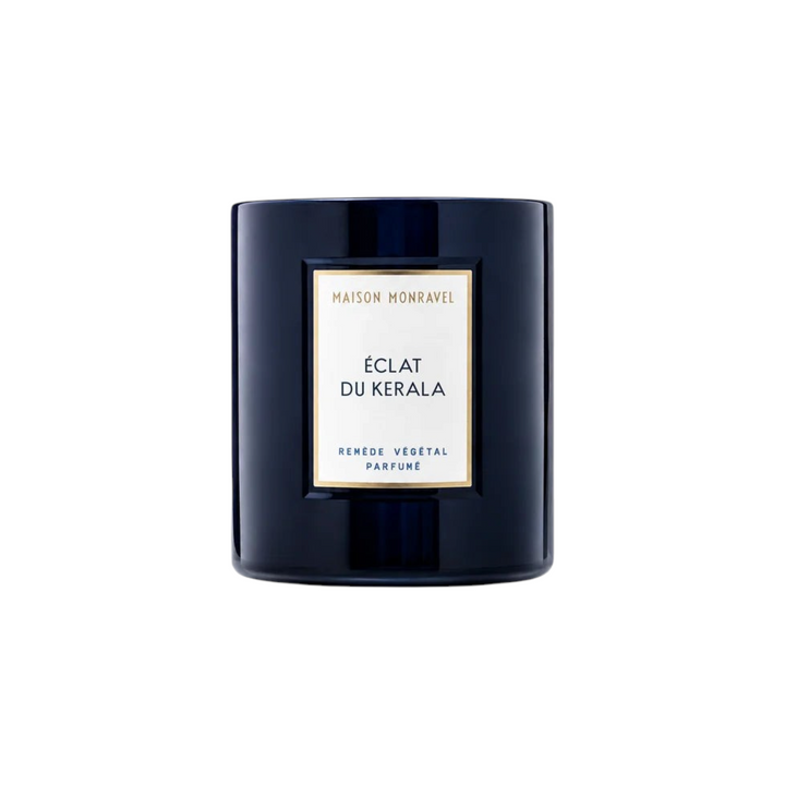 The Tiny Finch Candle Éclat du Kerala in a dark navy glass jar with a white label featuring gold accents.