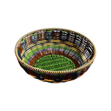 The Tiny Finch Maegen hand-woven green polypropylene bowl with a textured, multi-coloured rattan-style weave.