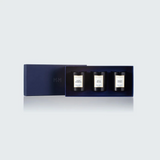 The Tiny Finch Candle Trio Gift Set No. 2 featuring three black rapeseed wax candles in a navy blue presentation box.