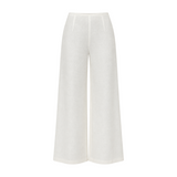 The Tiny Finch white high-waisted wide-leg linen pants with a flared hem and clean minimalist silhouette.