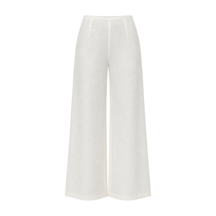 The Tiny Finch white high-waisted wide-leg linen pants with a flared hem and clean minimalist silhouette.