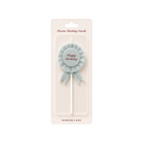 The Tiny Finch French blue rosette birthday candle with Happy Birthday script lettering in vintage ribbon style